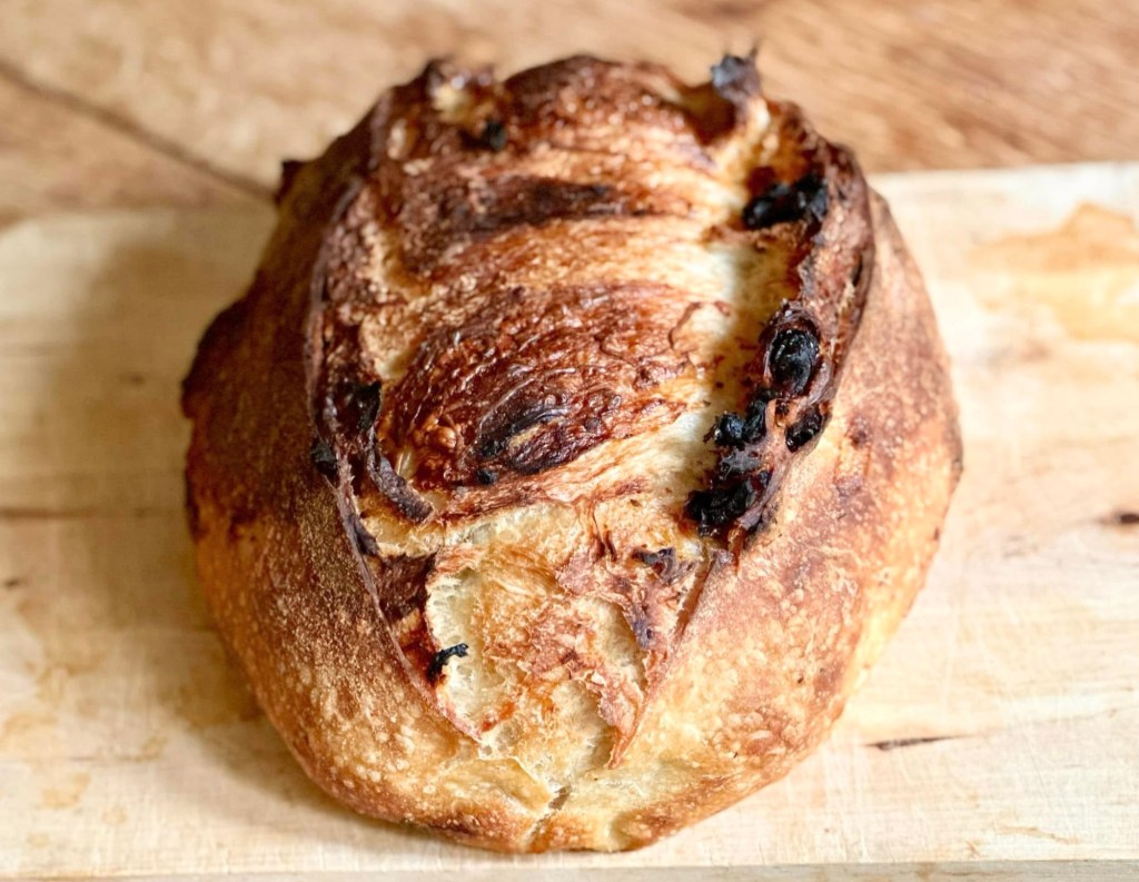 Rustic sourdough loaf with golden crust, flavored with fragrant orange and cranberry.