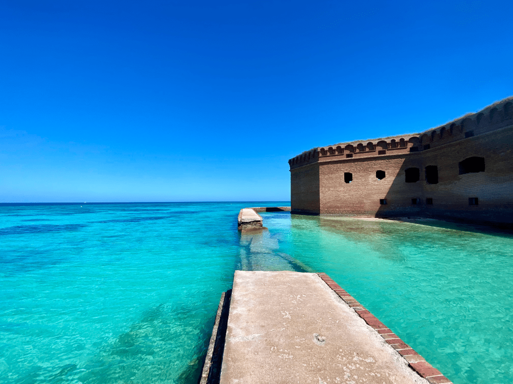 Moat path surrounding Fort Jefferson in the Dry Tortugas, surrounded by bright turquoise water.