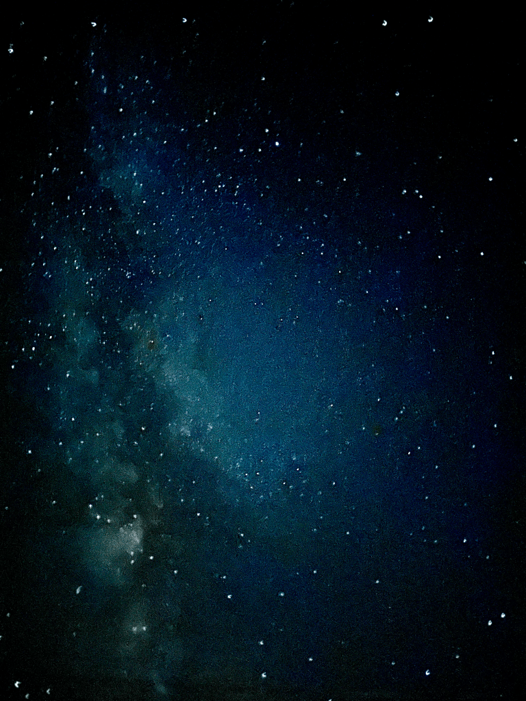 Milky Way core with dense star field against a deep blue night sky.