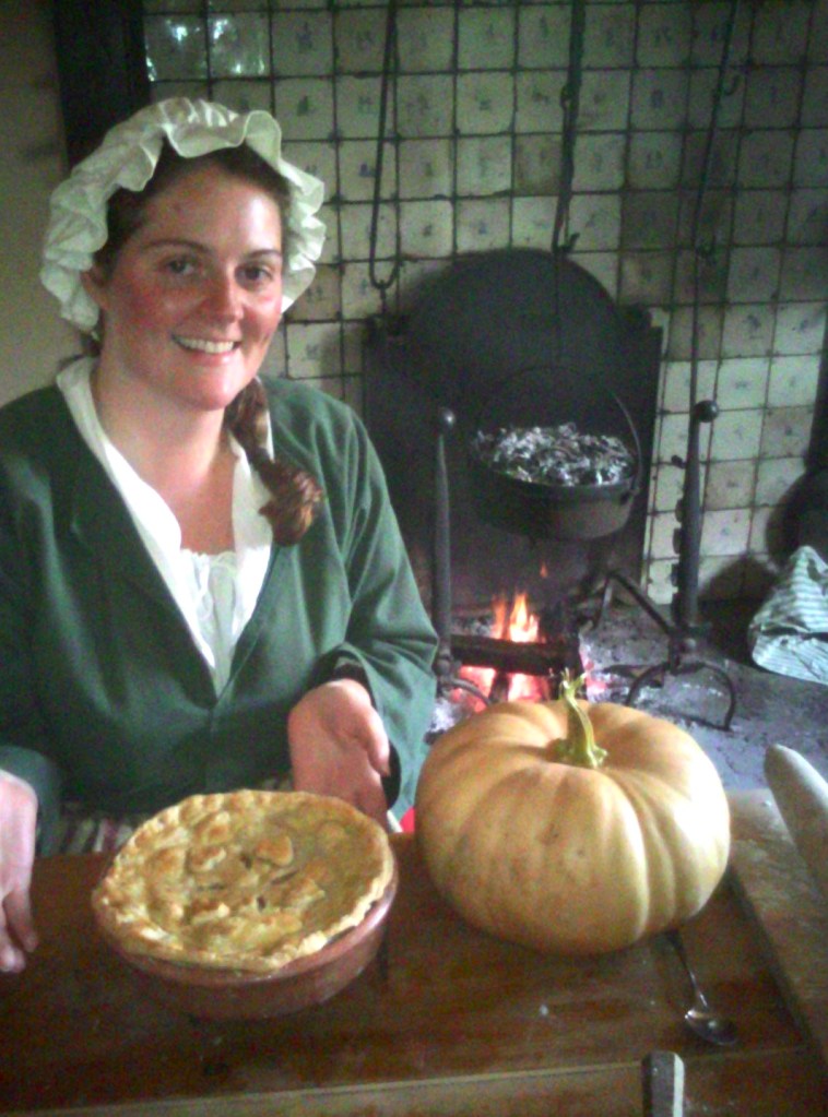 A woman dressed as the wife of a tenant farmer, demonstrating open-hearth cooking at Van Cortlandt Manor in Croton-on-Hudson, NY